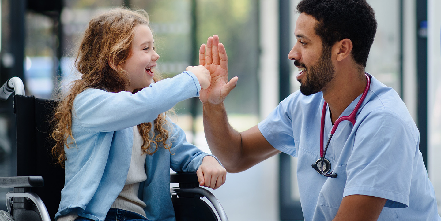 medical assisting high fiving child patient