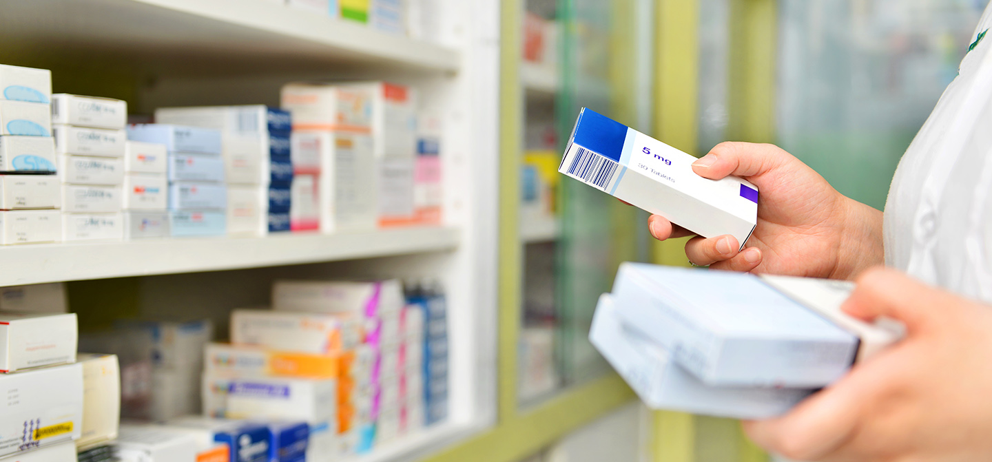 pharmacy with person holding medicine